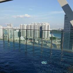 Hotel's 33rd floor infinity pool. Lady in the pool wearing a full bodysuit and head scarf.