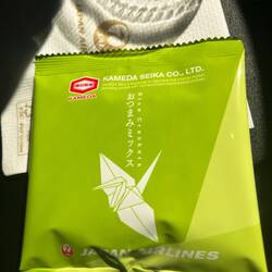 Rice crackers for "tastiness, happiness and peacefulness". JAL gives these out for snacks ...