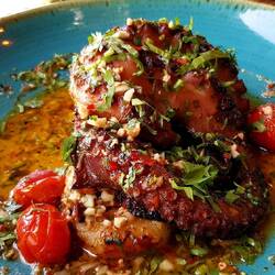 Octopus on a bed of potatoes with butter sauce, lemon and exotic spices.