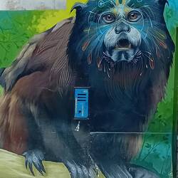 Mural of a strange jungle creature with features of sloth, dog, bear...?