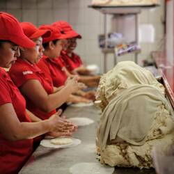 Lady workers making "gorditas" at a local restaurant.