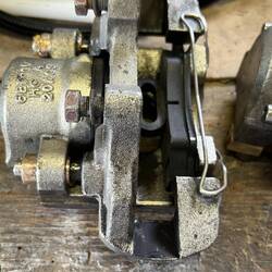 The bronze bushing is on both sides of the piston where the slider pin goes through.