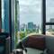 I want a lay on settee with a small drink table and a Singapore view!