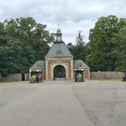 Das Eingangstor mit den Kassenhäusern davor. Die Feldsteinmauer ist 7km lang