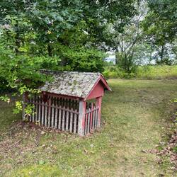 Another protective fence and cover for a grave.