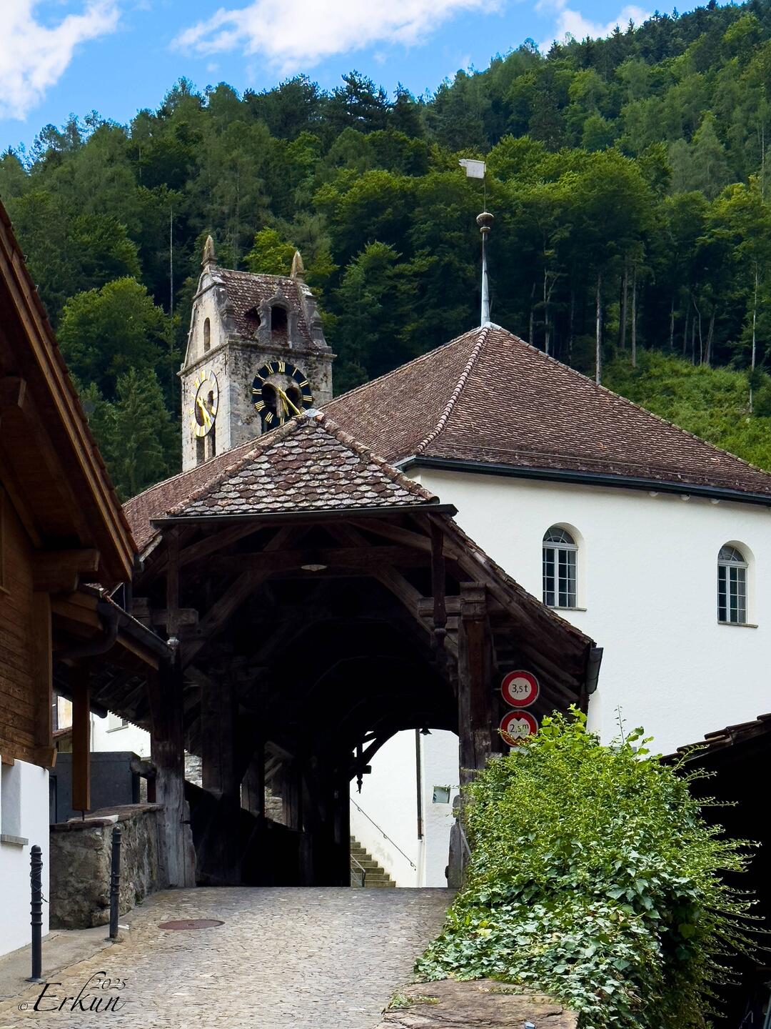 The covered bridge, and the Gsteig church and tower — Gsteigwiler, Switzerland.