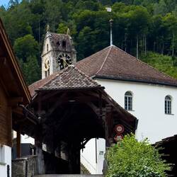 The covered bridge, and the Gsteig church and tower — Gsteigwiler, Switzerland.