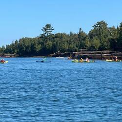 Kayakers touring the sea caves at Devils Island