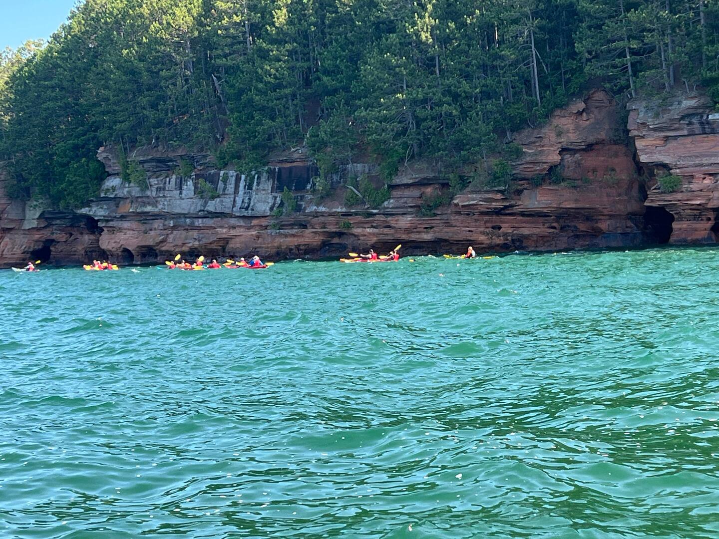 A lot of kayakers touring the mainland sea caves by Meyers Beach.