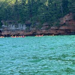 A lot of kayakers touring the mainland sea caves by Meyers Beach.