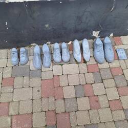 Shoes cast into the sidewalk denoting people in the adjacent house that were killed in 1941 Cesis.
