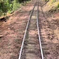 20 mph max. The rail joints are staggered... so the cars are always rocking and rolling