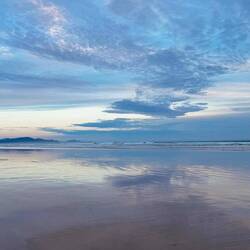 Sandy Point beach: the indigo outline of the national park peninsula on the horizon.