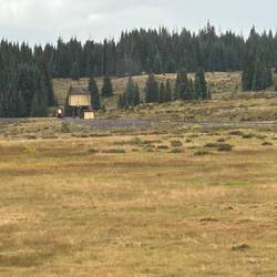 Looking back across the Los Pinos Curve at the locomotive water vat as the fire patrol passes it