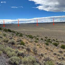 The arrows show where the track curves off the scarp and into the Cañon Bonito Valley