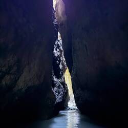 The path cut through the cave by the river