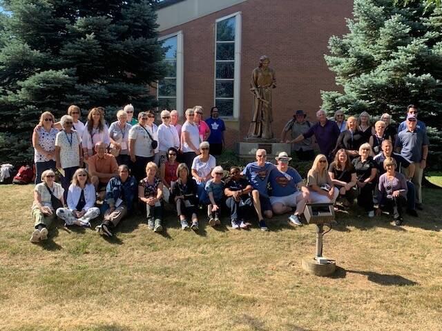 Group photo around statue of St. Joseph