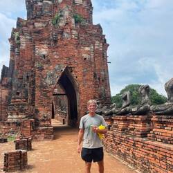 Doug amongst headless Buddhas in Wat Chaiwatthanaram