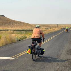 Desolate road except for cyclist
