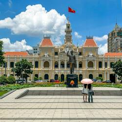 Standing in front of the building, is a statue of Ho Chi Minh, Vietnam's revered leader.