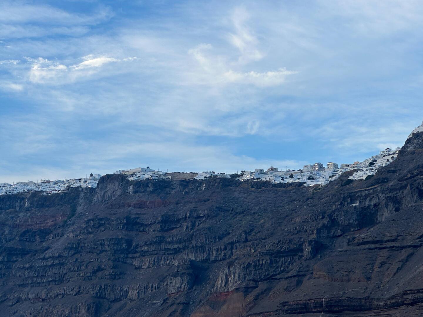 Houses and shops perched on the side of the cliff