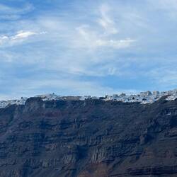 Houses and shops perched on the side of the cliff