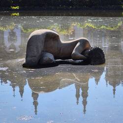 Sculpture of a woman "sleeping" in the water.