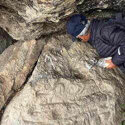 Our guide explaining that these carvings depict a field irrigation map