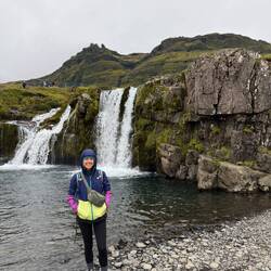 Chelsea at the waterfall in front of Kirkjufell mountain
