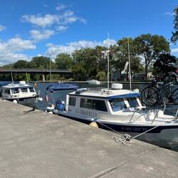 C-Traveler and C-Otter tied up to the free wall. Mystery Girl is behind the pontoon, out of sight.