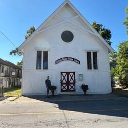 Rosanne standing in front of the Sylvan Beach Union Chapel