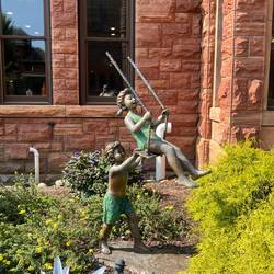 Kids swinging statue in front of Oneida County Courthouse