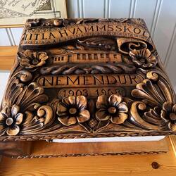 Beautiful carved book cover located in the school house.