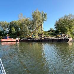 I assume this barge and equipment was dredging. They were just cleaning up the equipment.