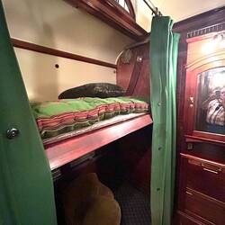 Bunk bed in the dropped-down position. Note original horsehair mattress.