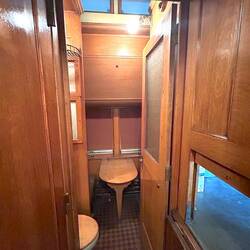 Porter/servant quarters, showing table and a portion of a toilet bowl. Galley hatch at right.