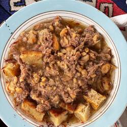 Once the lamb and chickpeas are mashed, you return them to the bowl of broth
