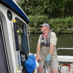 Your's truely driving from the cockpit helm. (Ugly glove on for grabbing grimey lock lines.