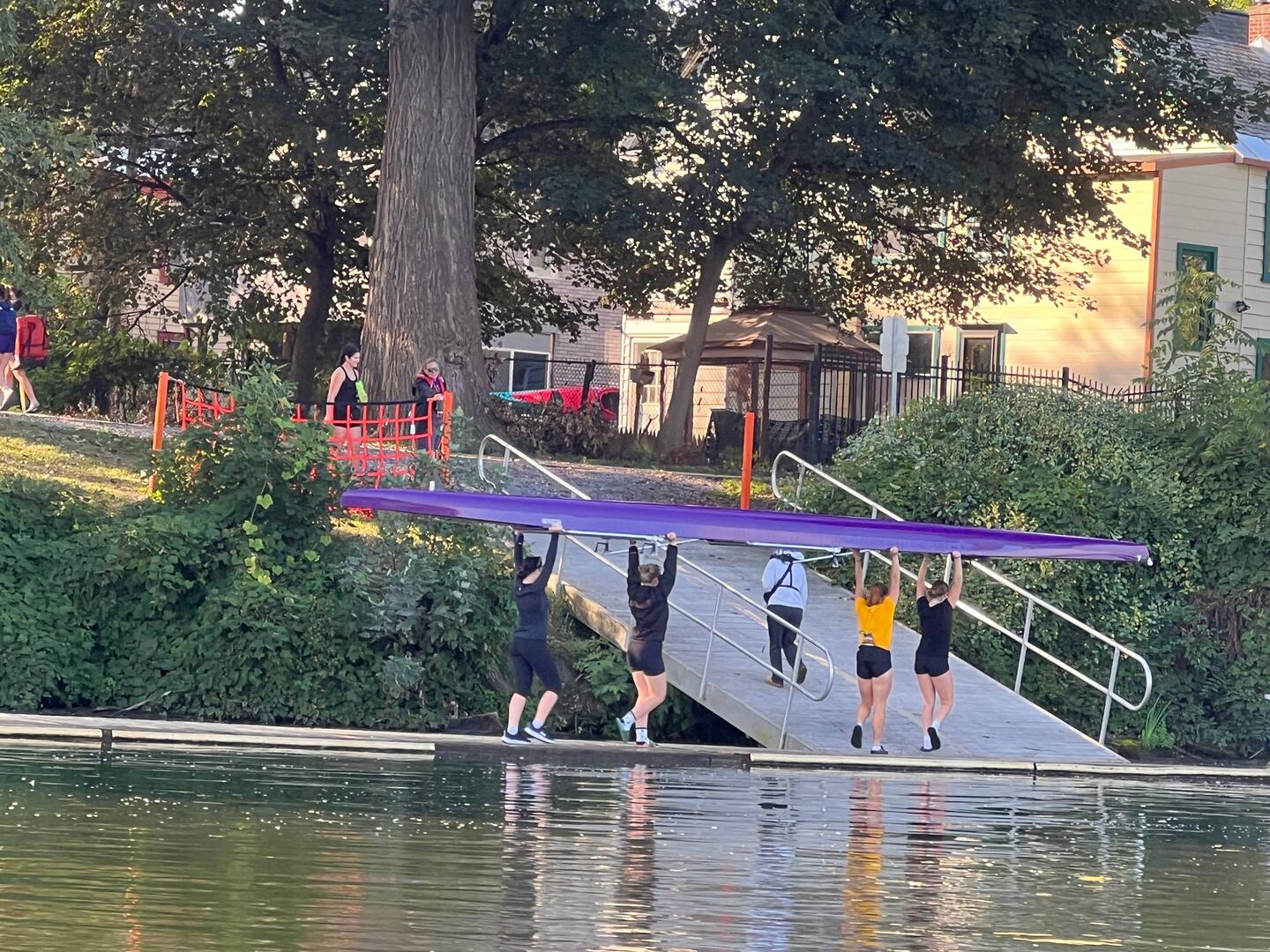 Rowing team putting the boat away