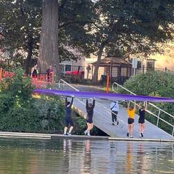 Rowing team putting the boat away