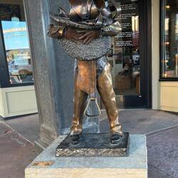 A small sculpture on a street corner in the historical downtown area