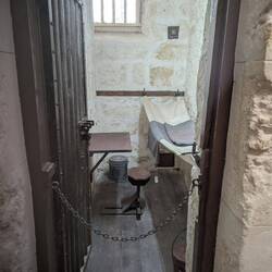The prisoner cell was hardly wider than the door