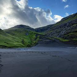 Black sand dunes covered in grass