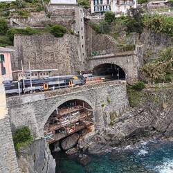 From the restaurant: tiny harbor, boat storage nestled below the train tracks, Riomaggiore