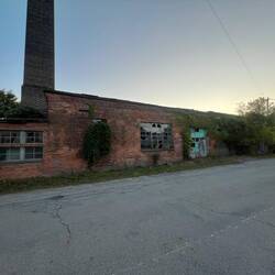 The old brewery building under the smokestack