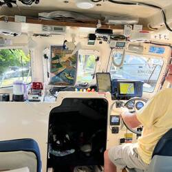 Rosanne's poster and me driving the boat back out the Enlarged Erie Canal