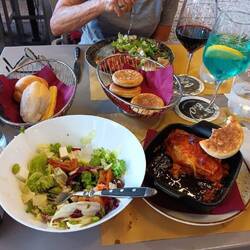 Dinner of lasagna, salad, wine, bread outdoors in Verona