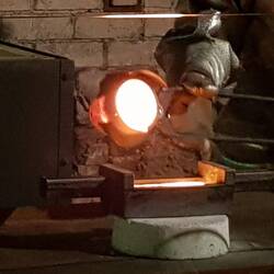 Pouring melted gold into mould