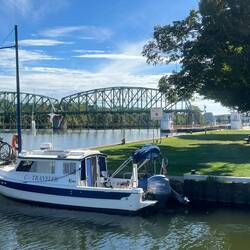 C-Traveler tied up at the west end of lock E15 wall in the little basin