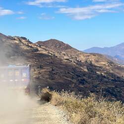 Dust clouds behind the lorries